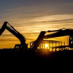 The setting sun silhouetting diggers and operatives working on Daedalus Common