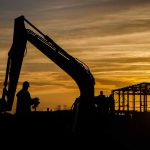 The setting sun silhouetting diggers and operatives working on Daedalus Common