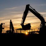 The setting sun silhouetting diggers and operatives working on Daedalus Common