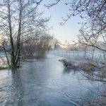 A flooded River Meon flows through the Meon Valley Hampshire near Droxford