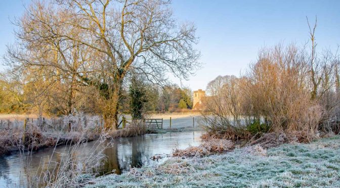 Meon Valley Hampshire The River Meon with St Mary and All Saints Church in the distance.